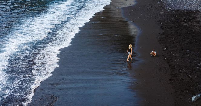 Family holiday on Tenerife, Spain, Europe. Mother and daughter outdoors on ocean. Portrait travel tourists - mom with child. Positive human emotions, active lifestyles. Happy young family on sea beach