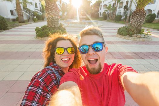 Travel, vacation and holiday concept - Young couple taking selfie outdoor.