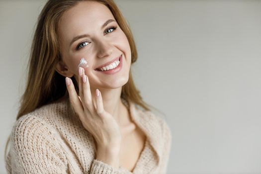 Young happy woman with cream . High quality photo