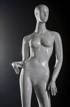 Female fashion mannequin against a black background