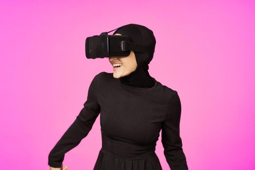 woman in black hijab glasses virtual reality technology movie watching. High quality photo