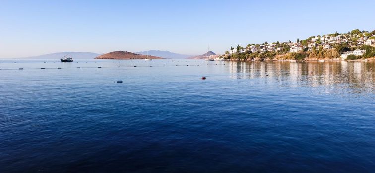 Aegean coast with marvelous blue water, islands, mountains and small white houses