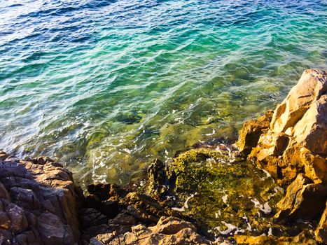 Blue water beatiful natural rocky sea shore in sun