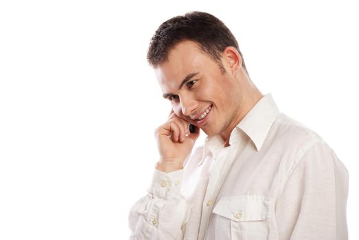 Young and healthy man smiling and talking on phone over white background