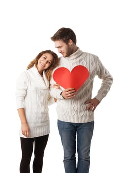 beautiful young couple holding a red heart isolated over white background