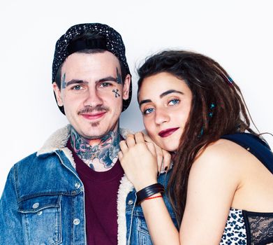 Young couple together. guy with tattoo, girlfriend wearing dreadlocks having fun on white background close up