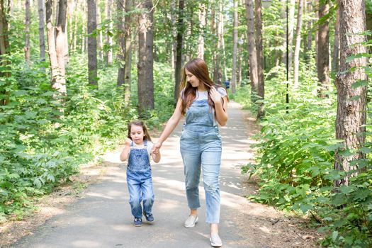 Family and nature concept - Mother and daughter spend time together outdoor.