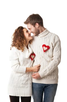 Portrait of joyful couple holding red hearts and laughing isolated on white