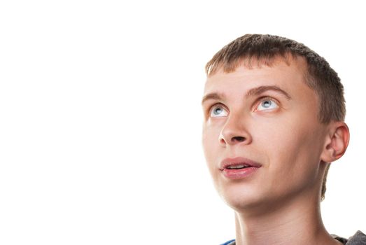 Young man looking at copyspace having a surprised look isolated on white background