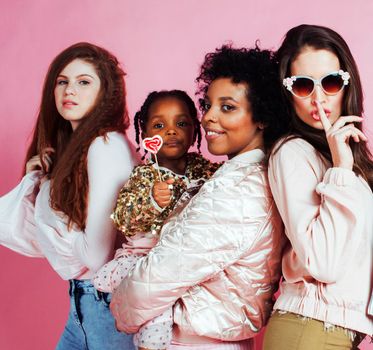 different nation girls with diversuty in skin, hair. Asian, scandinavian, african american cheerful emotional posing on pink background, woman day celebration, lifestyle people concept close up