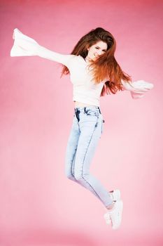 cute pretty red hair teenage girl on pink background, lifestyle modern people concept close up