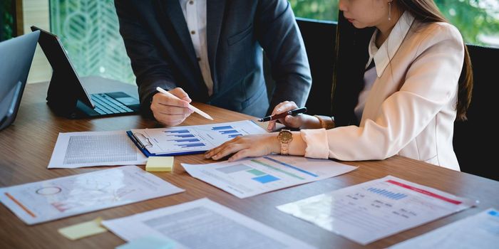 Business team working together and training to analyze technical price graph and indicator. Chart and stock trading computer screen