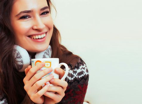 young pretty woman sitting in comfortable chair with coffee and blanket, winter season lifestyle people concept close up