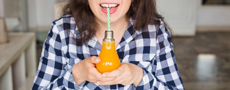 Health, food, diet and people concept - young woman drinking natural juice in a bottle and it seems to be tasty.