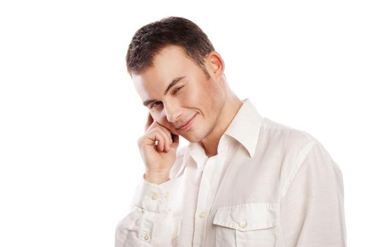 Young and healthy man smiling and talking on phone over white background