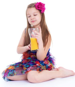 girl, fashion, rose in her hair and orange juice in a glass- Portrait of happy little girl drinking orange juice