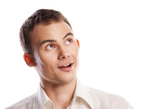 Handsome smiling young man looking up over white background