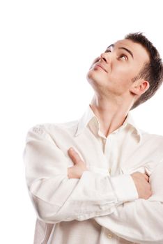 Handsome smiling young man looking up over white background