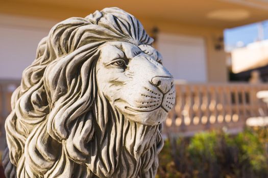 Stone lion statue. Marble Sculpture of a lion on pedestal.