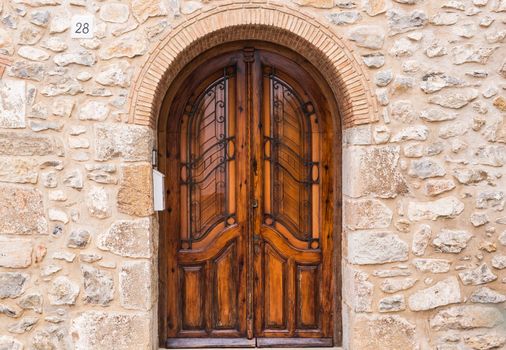 Brown Classic Wooden Door in Stone Wall.