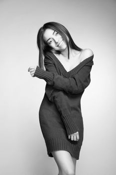 Portrait of attractive caucasian smiling woman with long hair on grey background