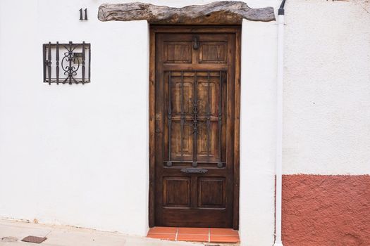 Brown Classic Wooden Door in Stone Wall.