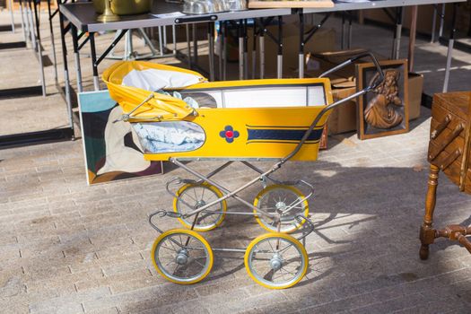 Vintage baby buggy or stroller, outdoors on flea market.