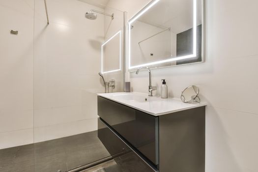 Interior of the modern bedroom with illuminated mirror