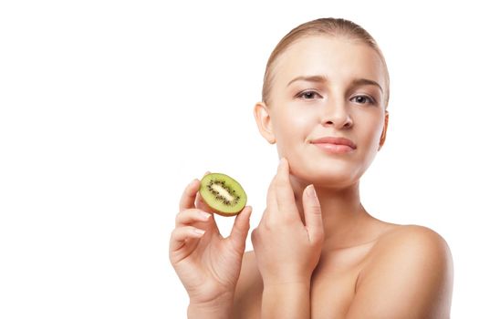 Beautiful smiling woman holding piece of kiwi. Beauty shot