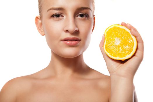 portrait of a young beautiful woman with orange over white background