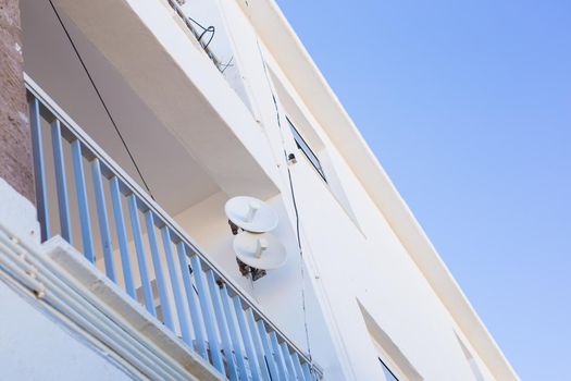 satellite dish and TV antennas on the house.