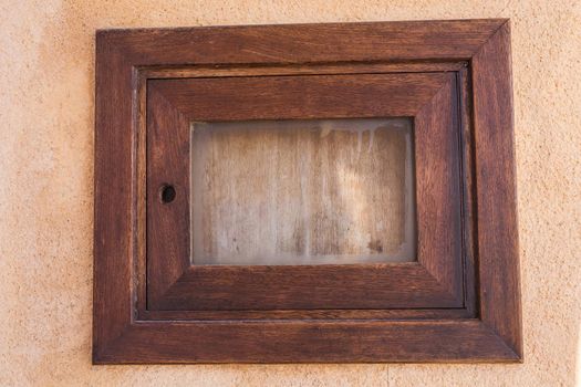 Small closed window in the stone wall.