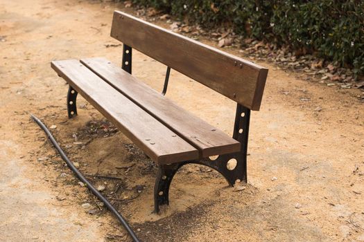 Wooden bench in the city park outdoors.