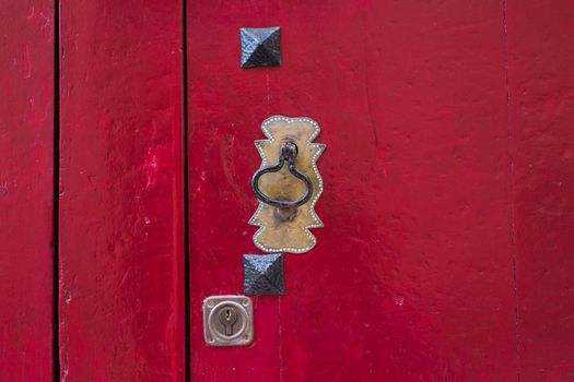 Ancient door knocker on a wooden door