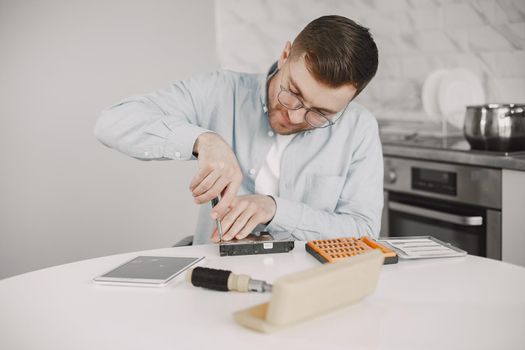 Disabled man on wheelchair like repairing. Staying at home, hobbies.