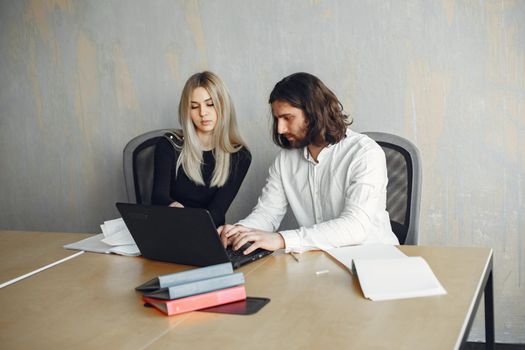 Handsome man in a white shirt. Partners together. Guy with a laptop.