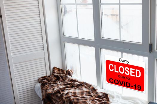 Business center closed due to COVID-19, sign with sorry in door window. Stores, restaurants, offices, other public places temporarily closed during coronavirus pandemic. Economy hit by corona virus.