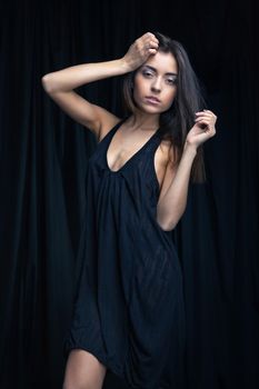 sensuall brunette woman in underwear, studio shot, dark background