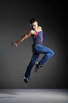 Cool looking dancer posing in front of the studio background