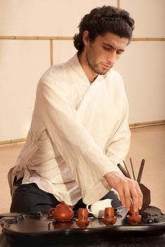 Chinese tea ceremony is perfomed by tea master in kimono
