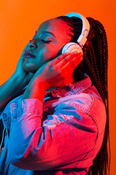 Portrait of beautiful African American woman joyful listening to music