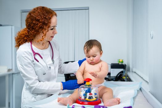 Little girl at doctor for checkup. Doctor pediatrician and baby patient. Child patient at doctor appointment. Pediatrician checking kid's health. Medical examination by a neonotologist doctor of baby.