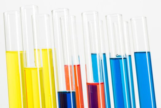 Science laboratory research and development. Modern biochemistry industry mockup. Close up test tubes with color liquid on white background. Chemical manufacture concept with glass equipment.