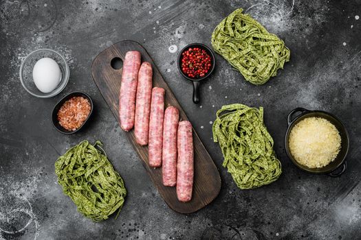 Raw Tagliatelle sausages ingredients set, on black dark stone table background, top view flat lay