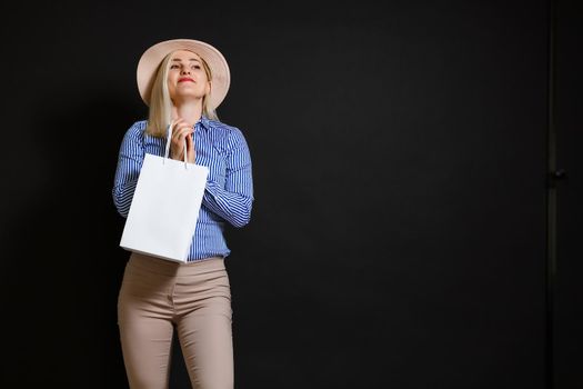 Shopping woman holding bags, isolated on black background. black friday concept