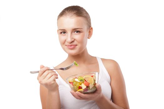 Pretty girl eating fruit salad, healthy fresh breakfast, dieting and health care concept isolated