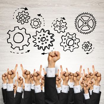 Group of hands of businesspeople showing gestures on wooden background