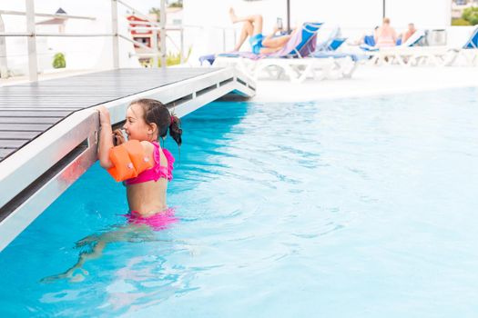 happy girl in the swimming in swimming suit.