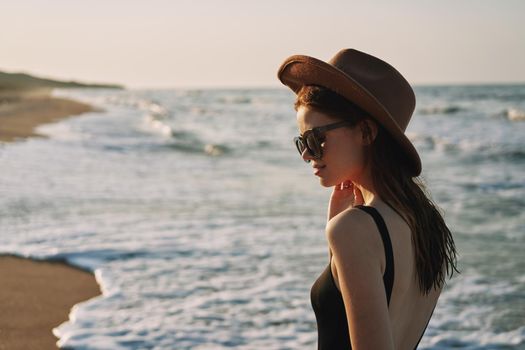 woman walking on the beach hat travel vacation sun. High quality photo