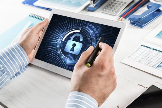 close-up, male hands with tablet. Businessman working at the table in office. computer security concept